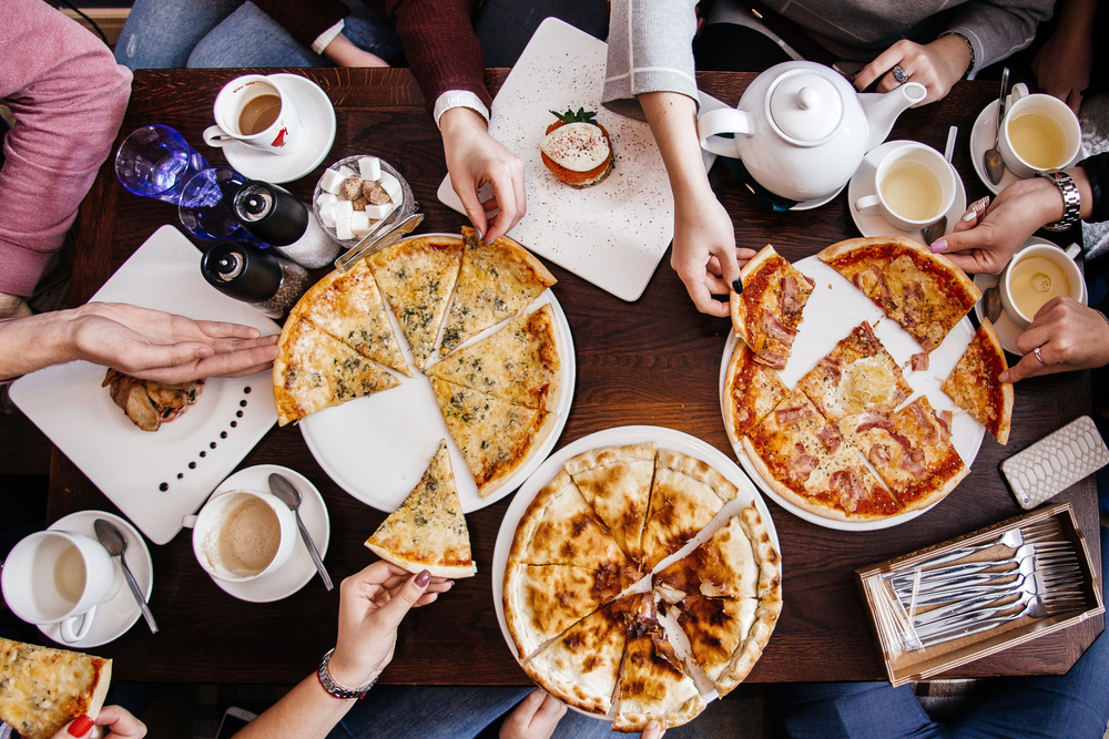 Company of People Eating Pizza